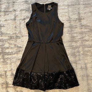 Shiny black A-line dress by Taylor w/ sequin trim